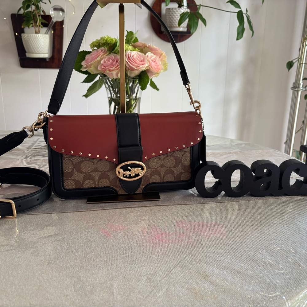 Coach Georgie shoulder bag in color block signature canvas with rivets.